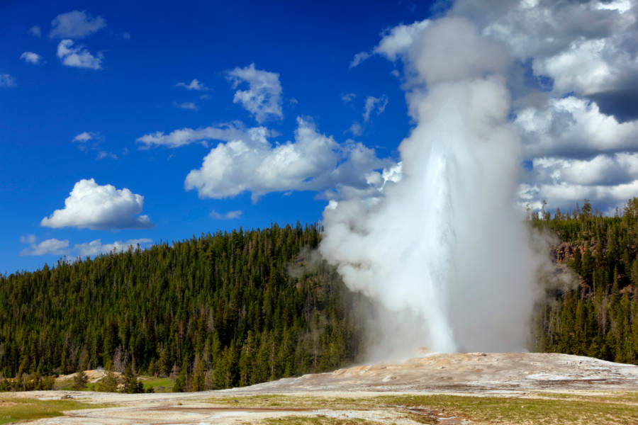 Let the Old Faithful Geyser put on a show as you enjoy from a private terrace at a historic hotel.